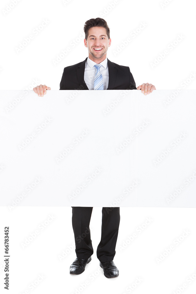 Confident Businessman Showing Billboard