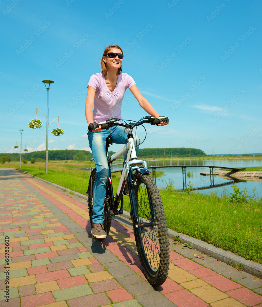 Young woman is riding on her bicycle