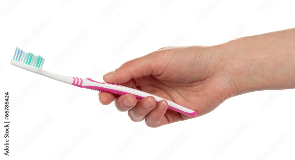 Toothbrush in the female hand Toothbrush in the female hand