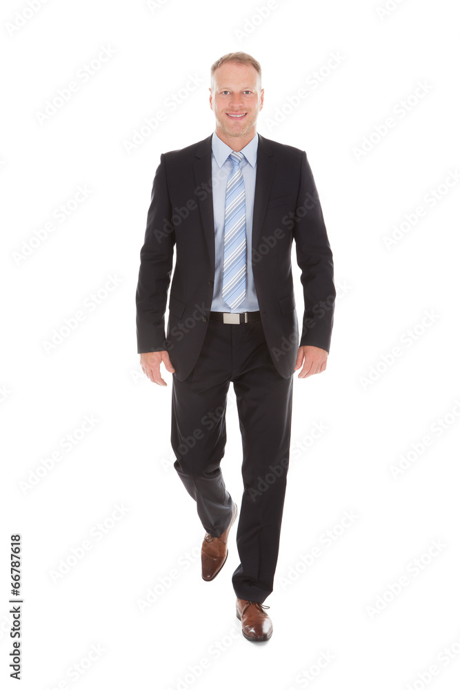Confident Businessman Walking Over White Background Confident Businessman Walking Over White Background