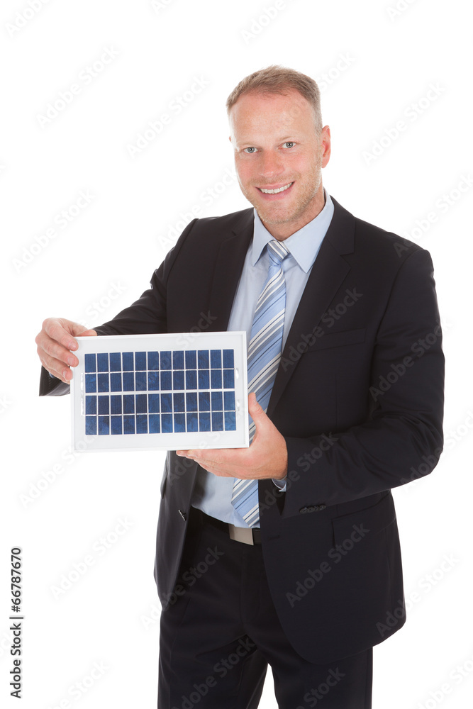 Smiling Businessman Holding Solar Panel Smiling Businessman Holding Solar Panel