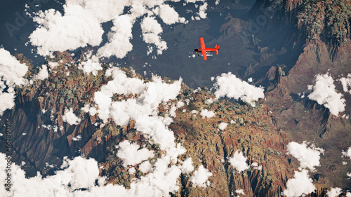 Airplane flying over rocky dry landscape and clouds. Aerial shot