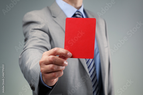 Businessman showing the red card photo