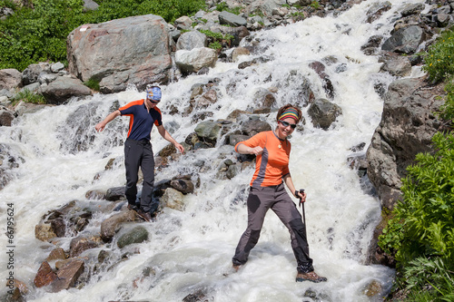 Konstfotografi Trekkers are crossing mountanious river in Zemo (upper) Svaneti,