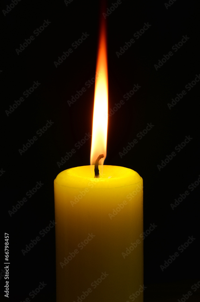 Closeup of burning candle on black background Closeup of burning candle on black background