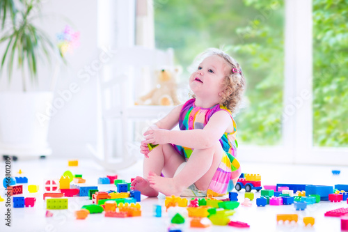 Happy girl playing with blocks