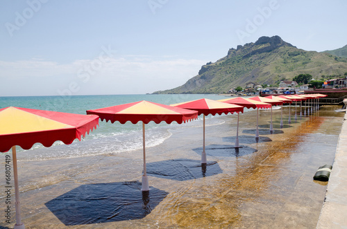 Beach umbrellas on a sea beach in Crimea