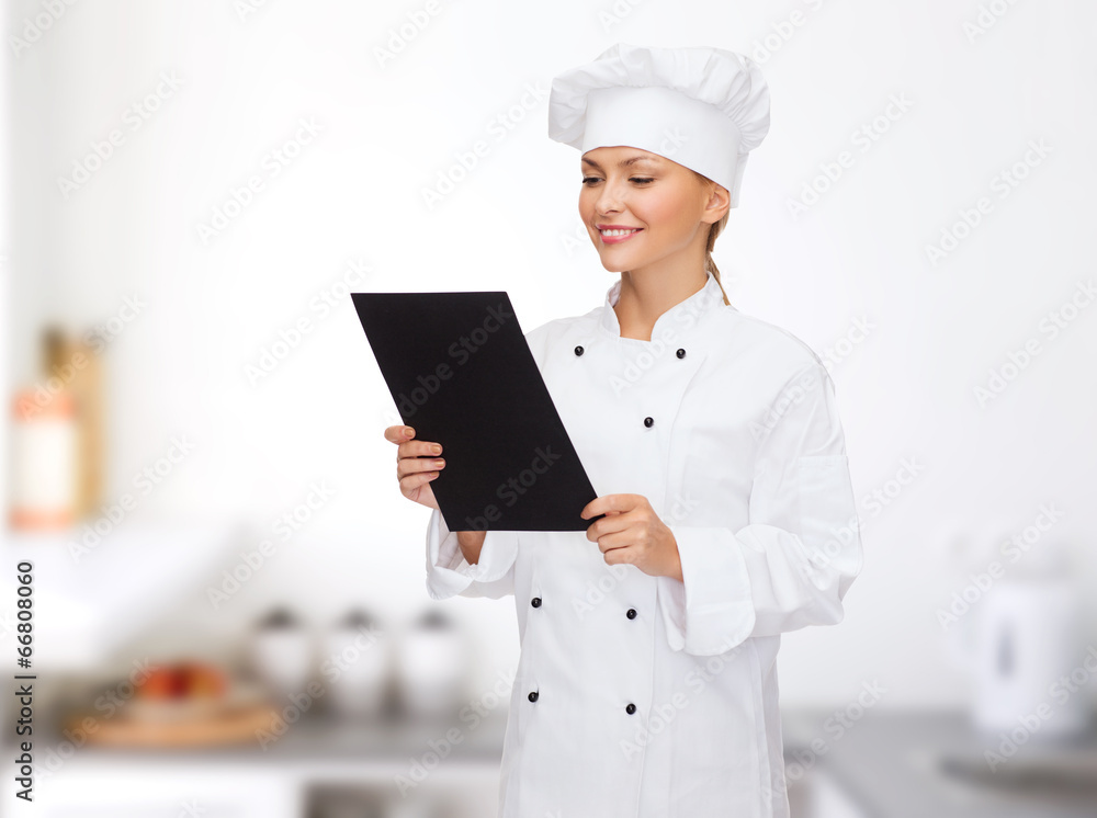 smiling female chef with black blank paper smiling female chef with black blank paper