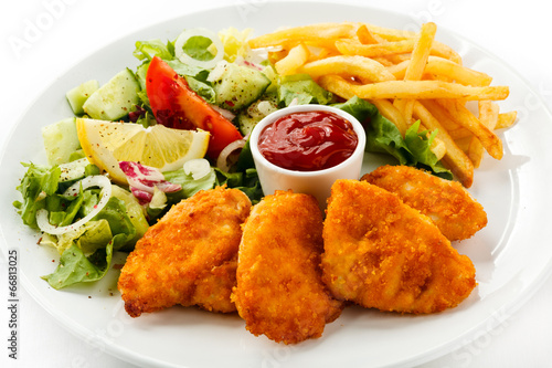 Fried chicken nuggets, French fries and vegetables