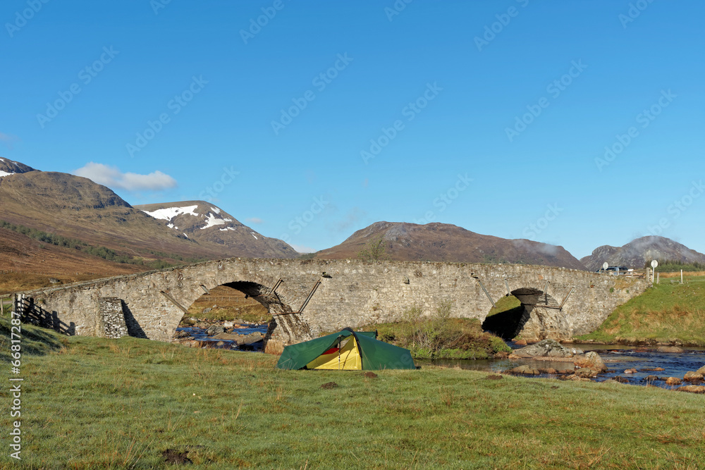 Tent by Spey river at Garva bridge, Scotland in spring