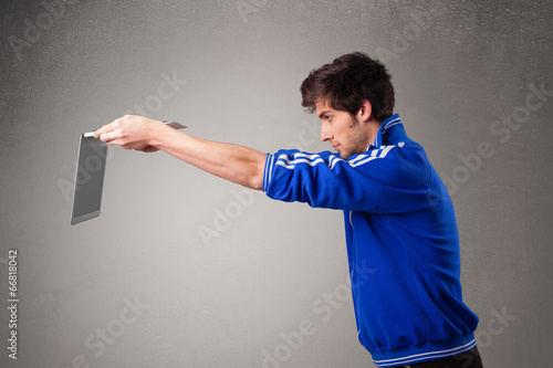 Attractive man holding modern notebook