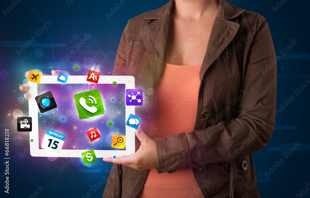 Lady holding a tablet with modern colorful apps and icons Lady holding a tablet with modern colorful apps and icons