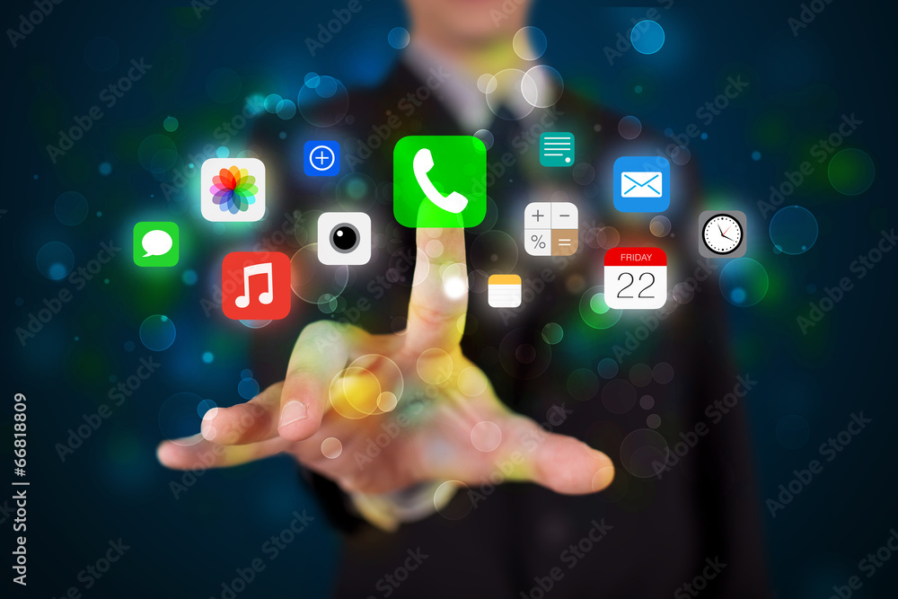 Fototapeta premium Handsome businessman pressing colorful mobile app icons with bok