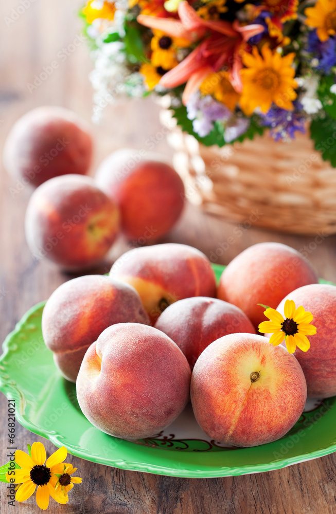Fresh ripe peaches on a plate, selective focus Fresh ripe peaches on a plate, selective focus