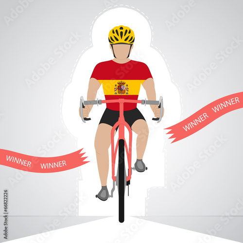 Spanish cyclist in front view crossing red finish line