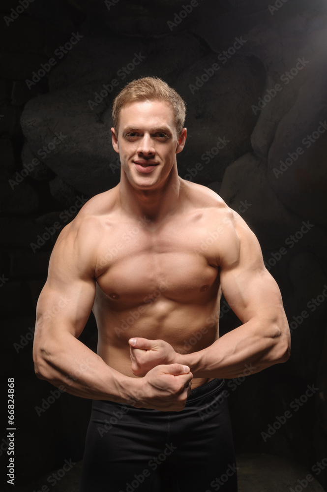 Fototapeta premium Athletic man on black backgrounds