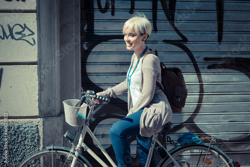 beautiful young blonde short hair hipster woman with bike