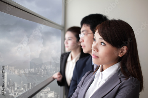 Business team look city through window