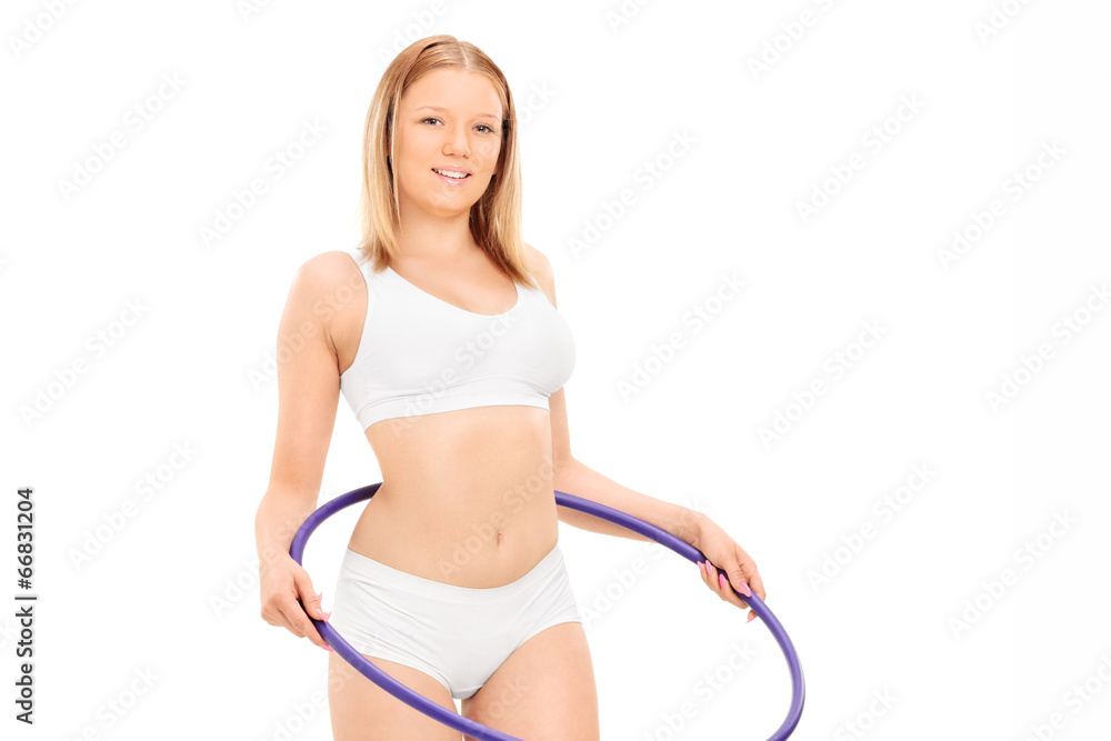 Woman in cotton underwear exercising with hula hoop Woman in cotton underwear exercising with hula hoop