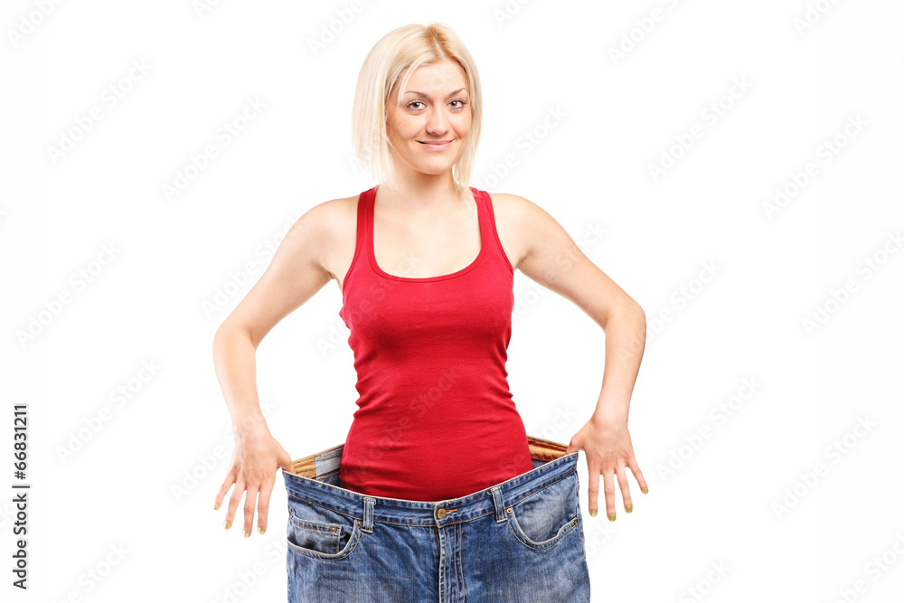 Fototapeta premium Woman standing in a pair of oversized jeans