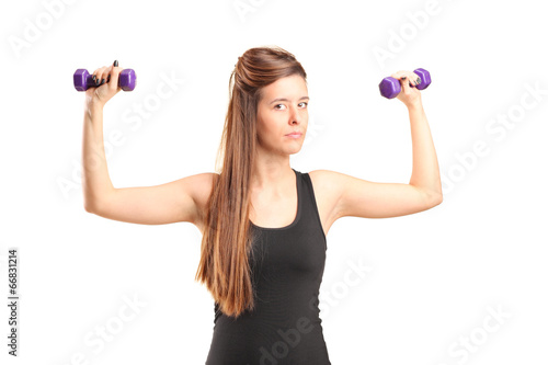 Young girl exercising with dumbbells