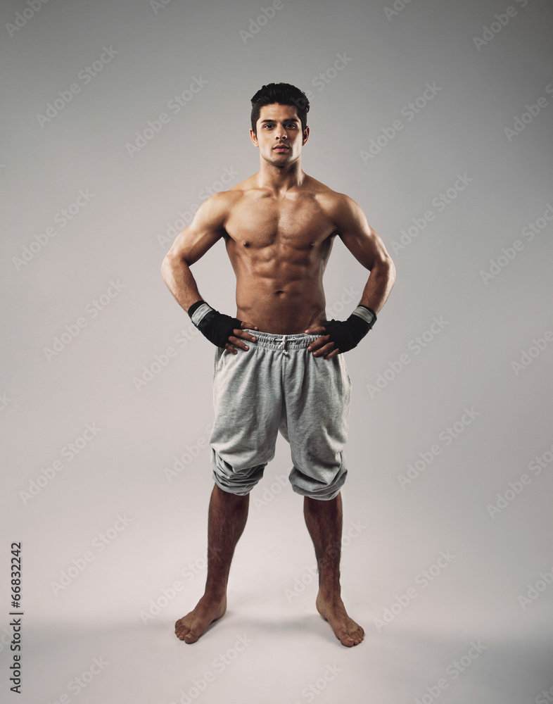 Shirtless muscular man posing in sweatpants
