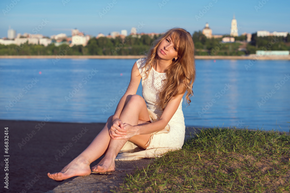 Sunny outdoors portrait of charming romantic girl with long hair