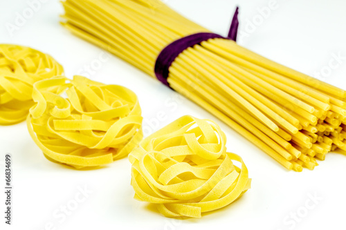 Uncooked Italian tagliatelle and spaghetti pasta