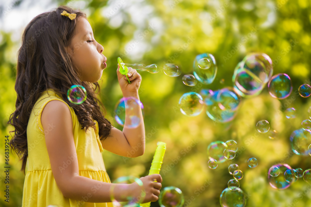 Little girl blowing soap bubble Little girl blowing soap bubble