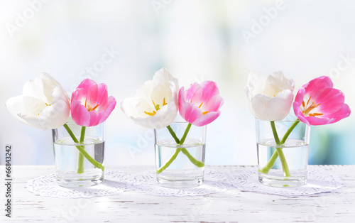 Fototapeta Naklejka Na Ścianę i Meble -  Beautiful tulips in bucket in vase on table on light background