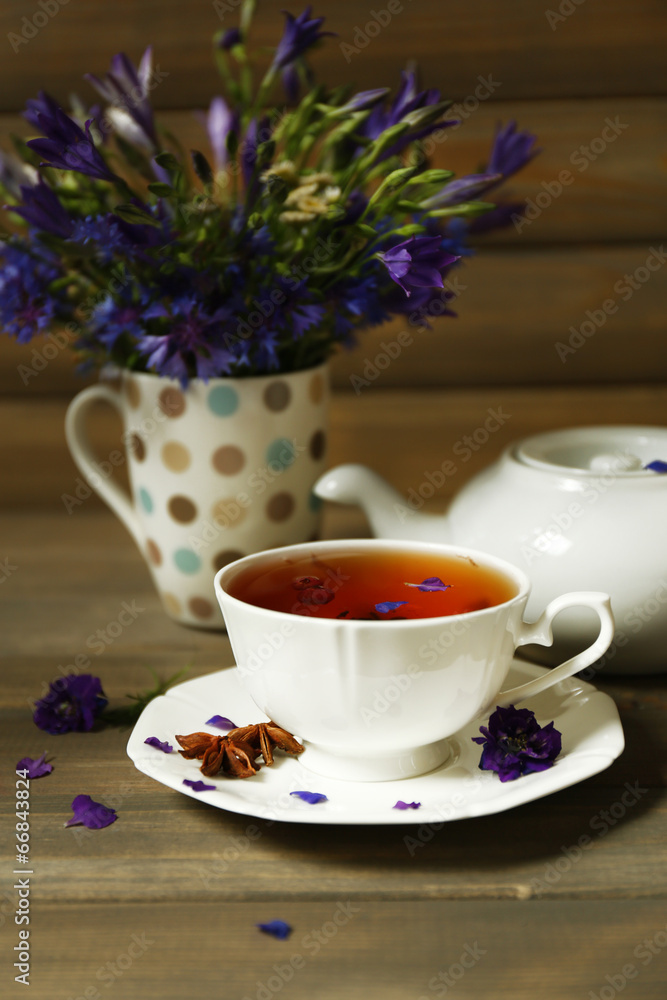 Cup of fresh herbal tea on wooden table Cup of fresh herbal tea on wooden table