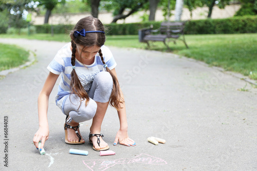 Cute girl drawing with chal...