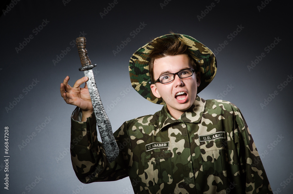 Funny soldier against the dark background Funny soldier against the dark background