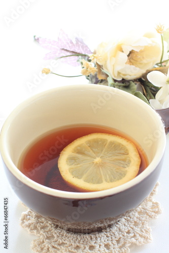 Lemon tea with flower on background