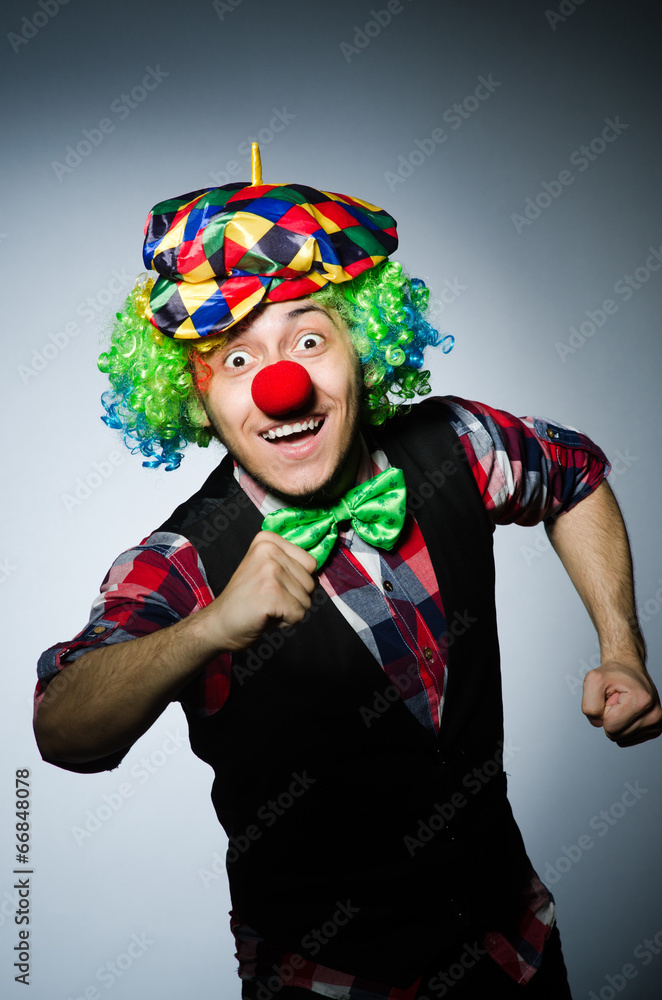 Funny clown against the dark background Funny clown against the dark background