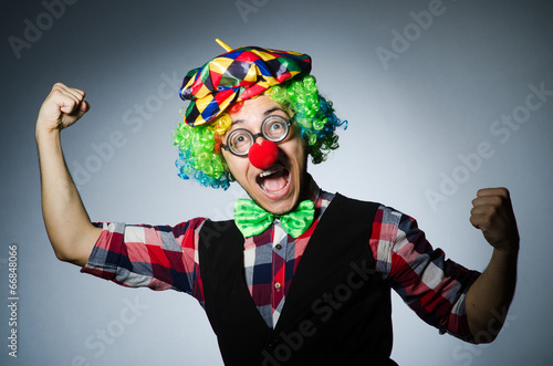 Funny clown against the dark background