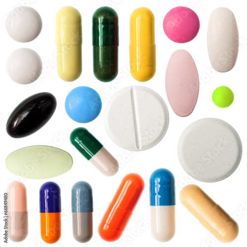 Pills and capsules on white background