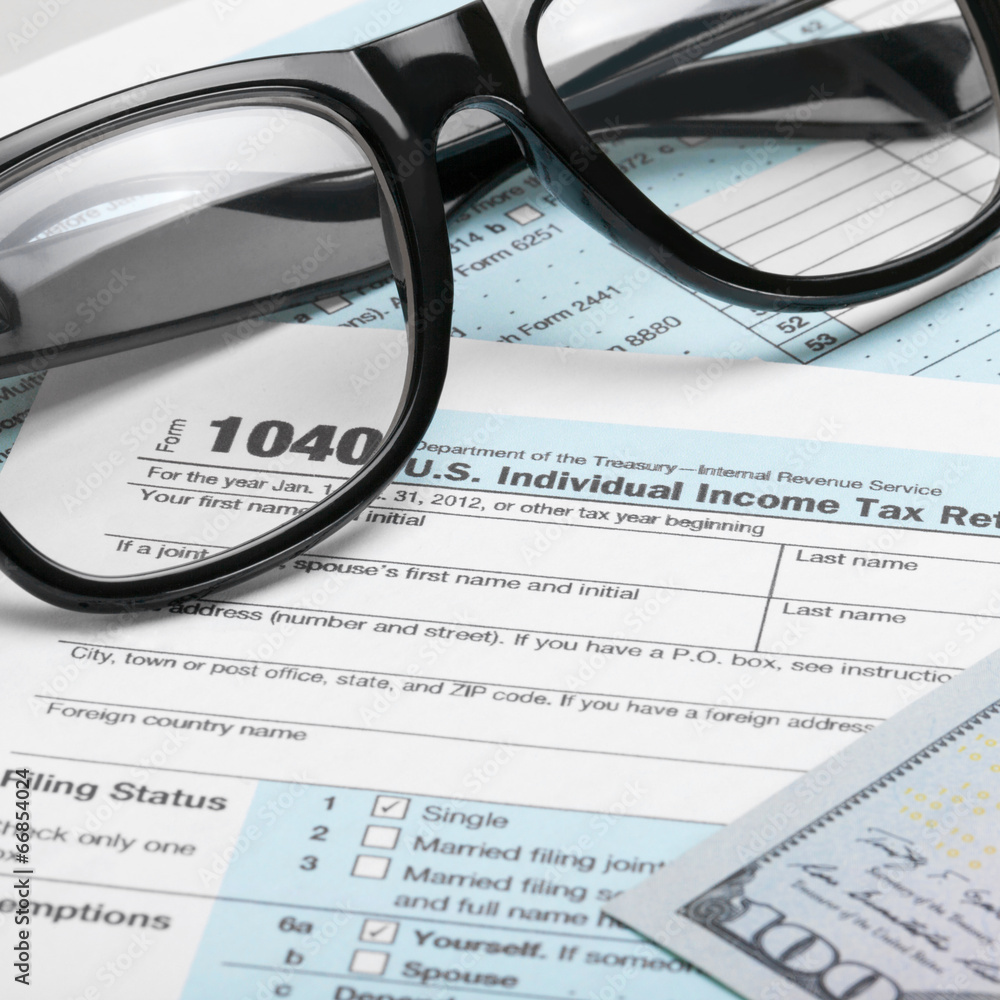 US Tax Form 1040 with dollars and glasses - 1 to 1 ratio US Tax Form 1040 with dollars and glasses - 1 to 1 ratio