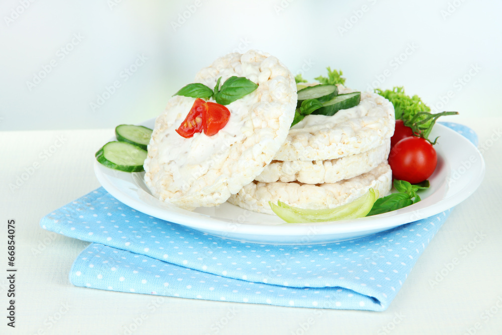 Tasty crispbreads with vegetables on white table Tasty crispbreads with vegetables on white table