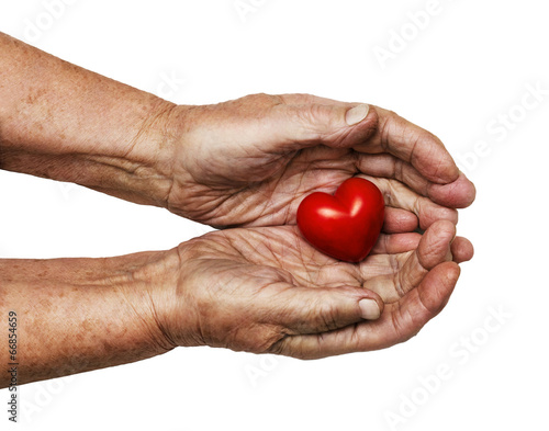 elderly woman keeping red heart in her palms