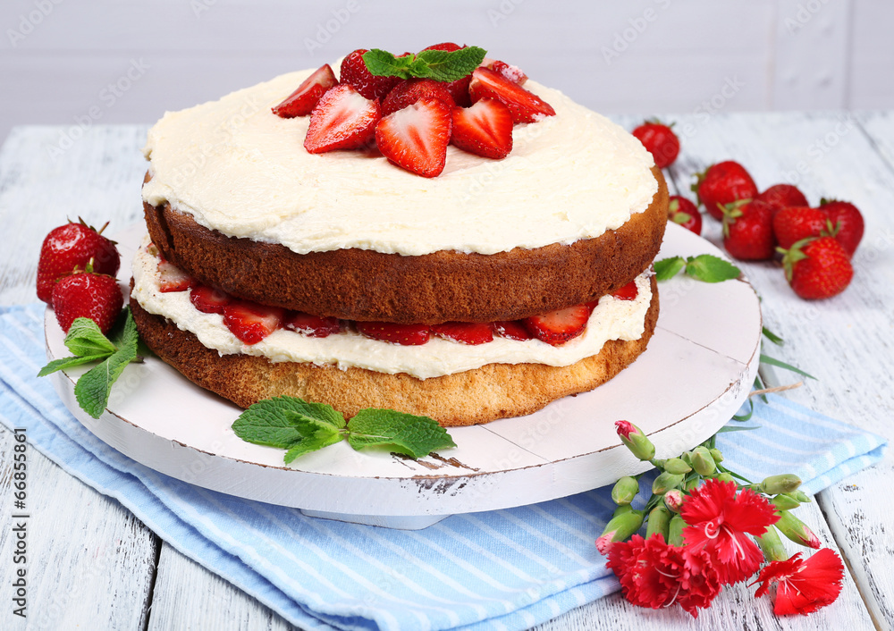Delicious biscuit cake with strawberries on table close-up Delicious biscuit cake with strawberries on table close-up