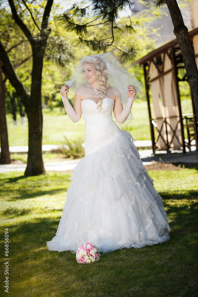 beautiful bride on a green grass in wedding day beautiful bride on a green grass in wedding day