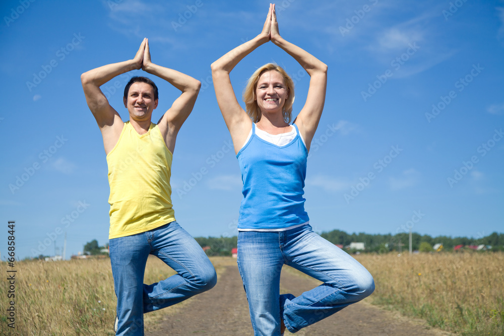 Couple elderly people doing yoga outdoors Couple elderly people doing yoga outdoors