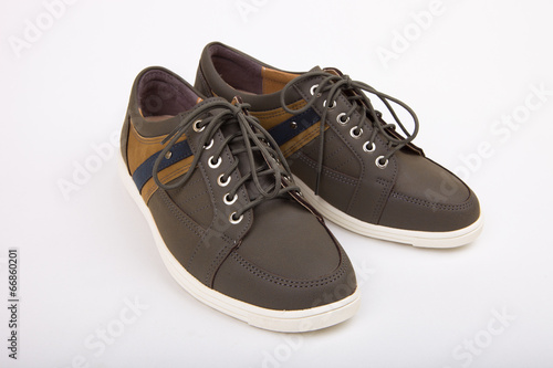 Having stripe pattern on side brown shoes on a white background