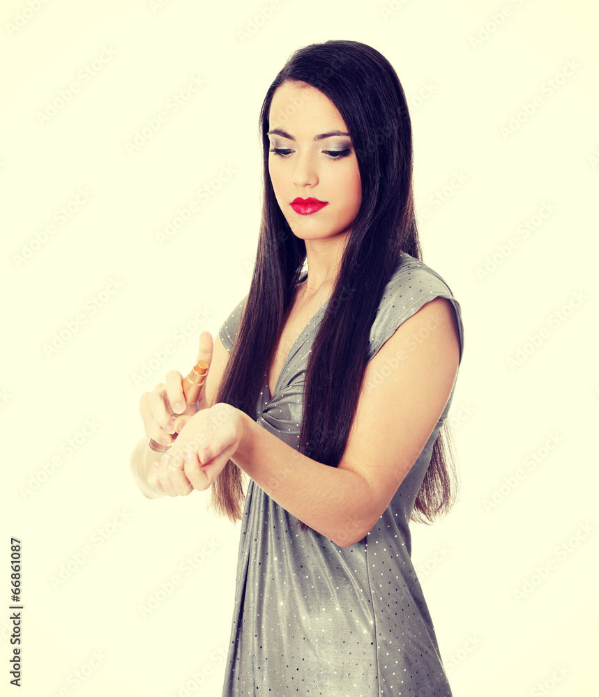 Beautiful woman applying perfume Beautiful woman applying perfume