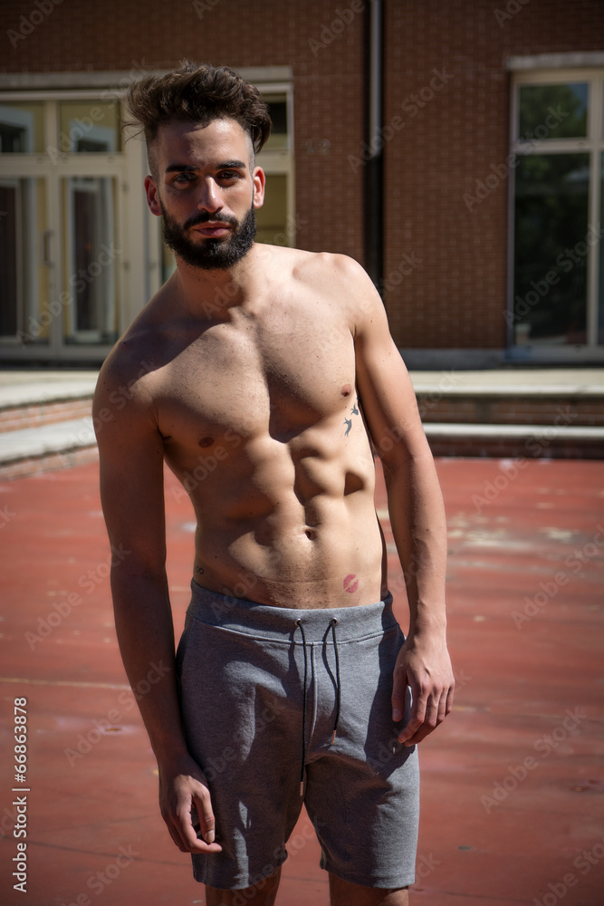 Handsome shirtless young man with beard