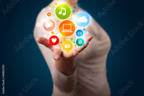 Wallpaper Mural Young woman presenting colorful technology icons and symbols Torontodigital.ca