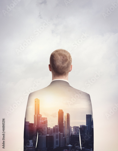 double exposure of businessman and city