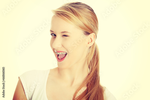 Young student woman with big smile blinking.