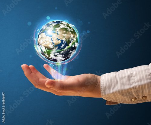 Woman holding a glowing earth globe